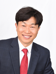 A headshot of librarian Jungmin Byun; he is wearing a white shirt with a red tie and a black suit