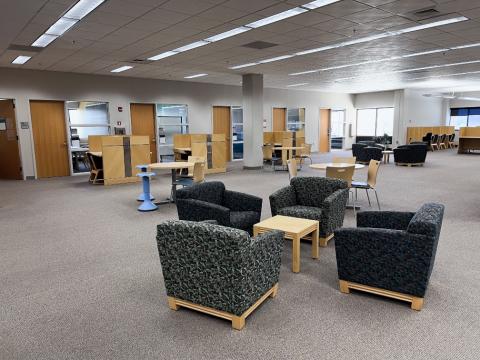 chairs and tables in the library's collaboration space