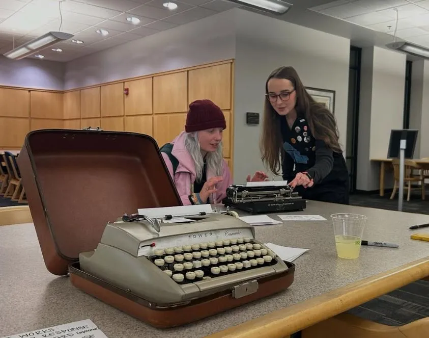students working at a typewriter
